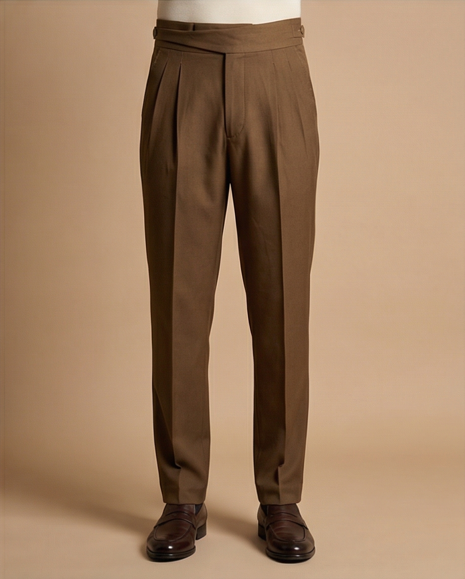 Brown pleated pants on a beige background